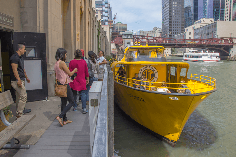 Wheelchair user safely boarding a Chicago Water Taxi via an accessible ramp at the dock