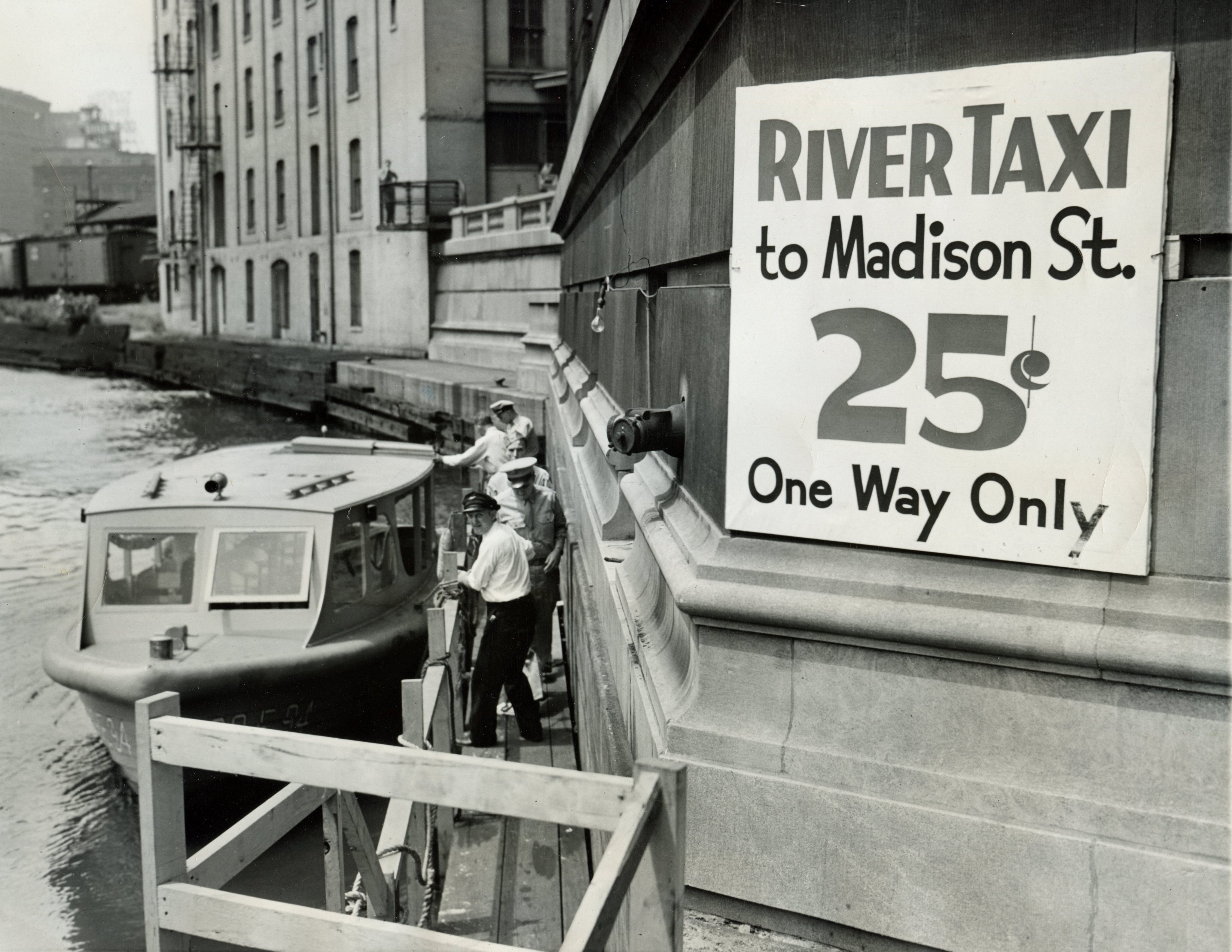 Historical 1943 black and white photo of a Wendella water taxi and 25-cent fare sign in Chicago