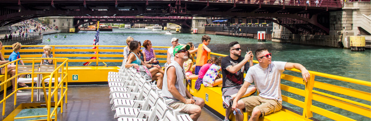 people traveling on a boat sailing down the Chicago River